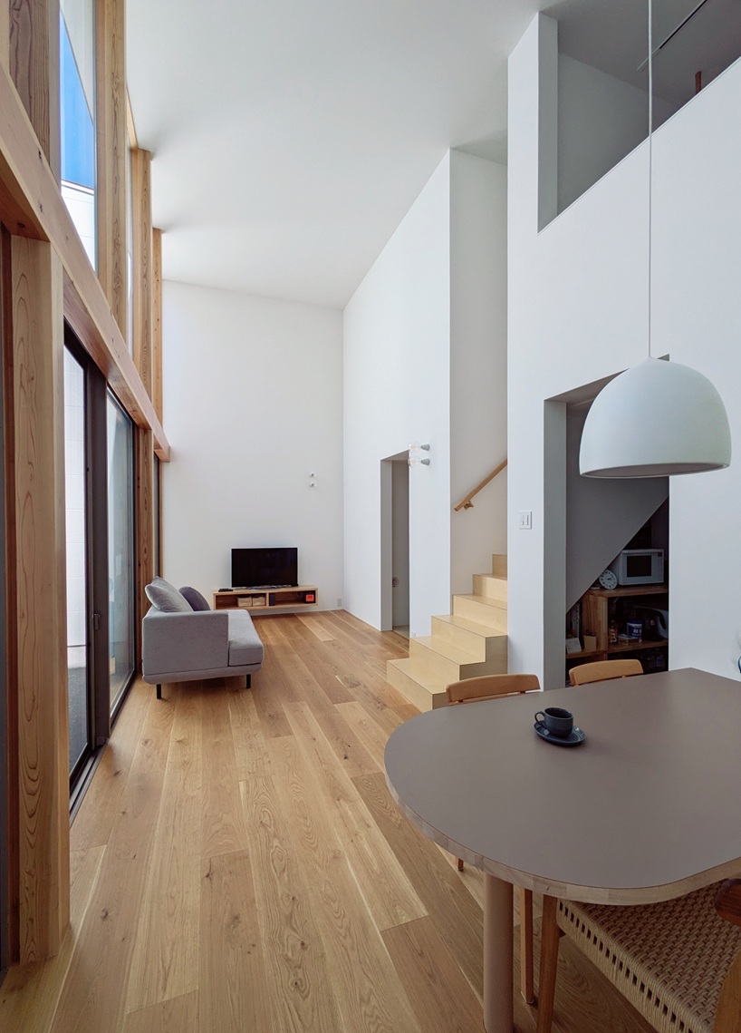 wooden facade parts like a curtain revealing japanese residence's sunlit interiors