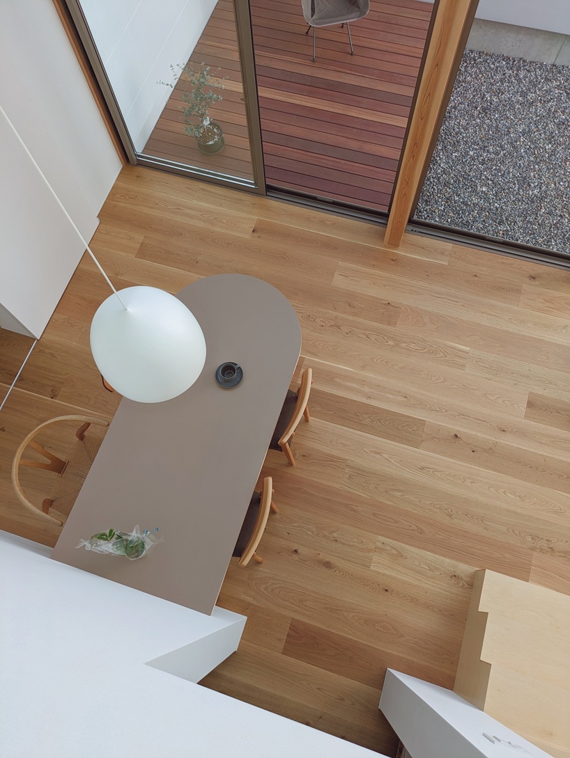 wooden facade parts like a curtain revealing japanese residence's sunlit interiors