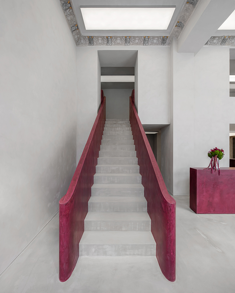 parabolic structures painted in burgundy stucco outline stockholm flagship for chimi eyewear