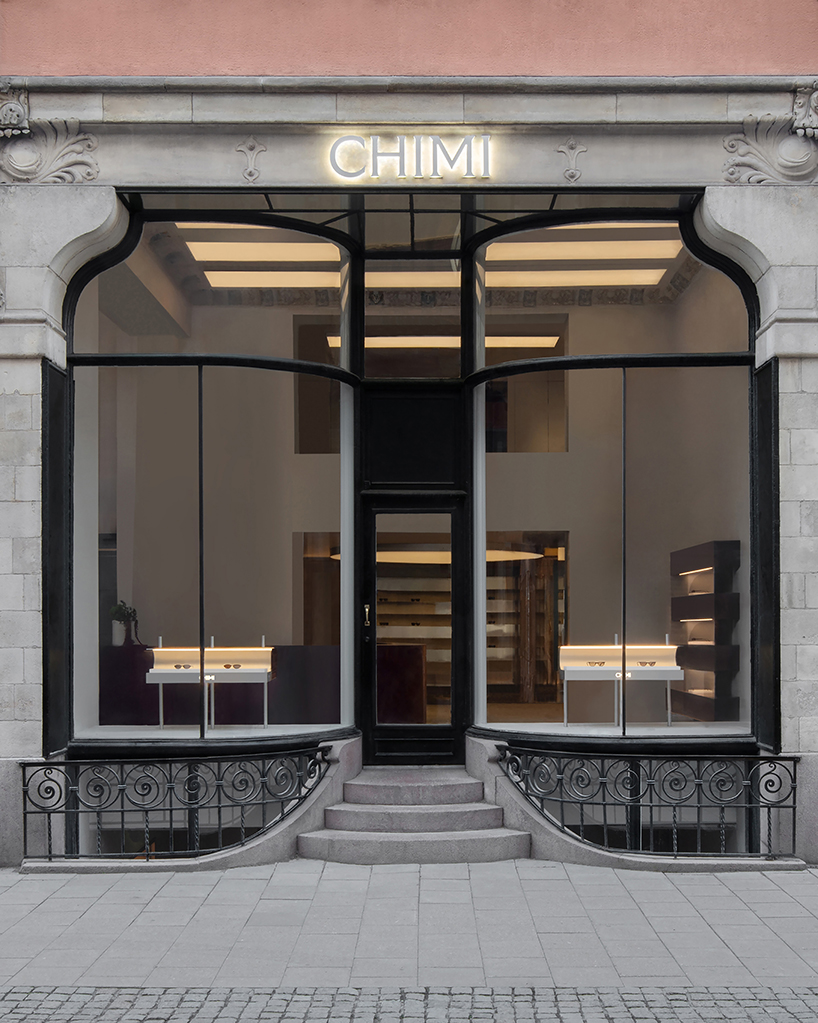 parabolic structures painted in burgundy stucco outline stockholm flagship for chimi eyewear