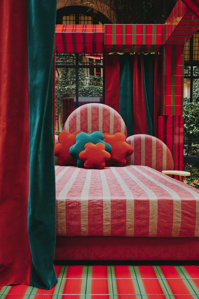 green and red ceramic tiles clad sculptural daybed by uchronia at hôtel plaza athénée, paris
