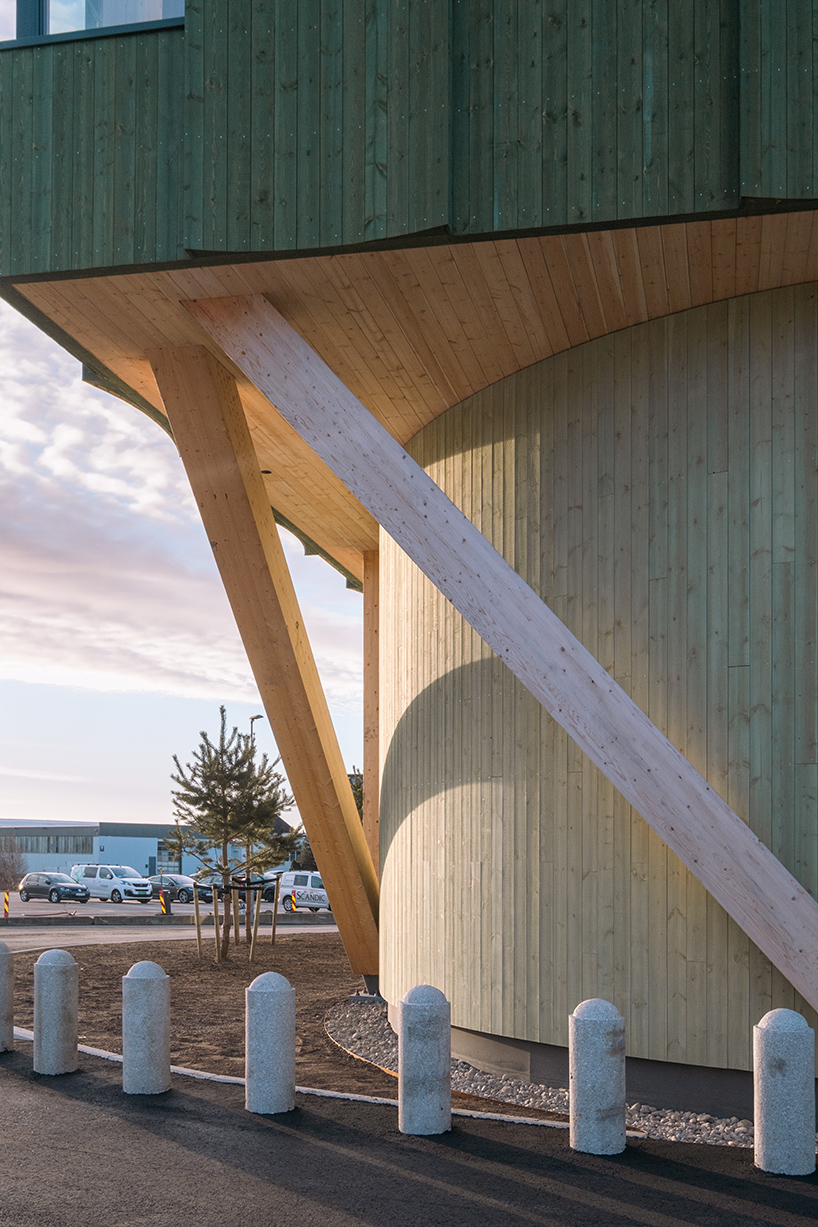 green timber curves sculpt rhythmic facade for office building in norway