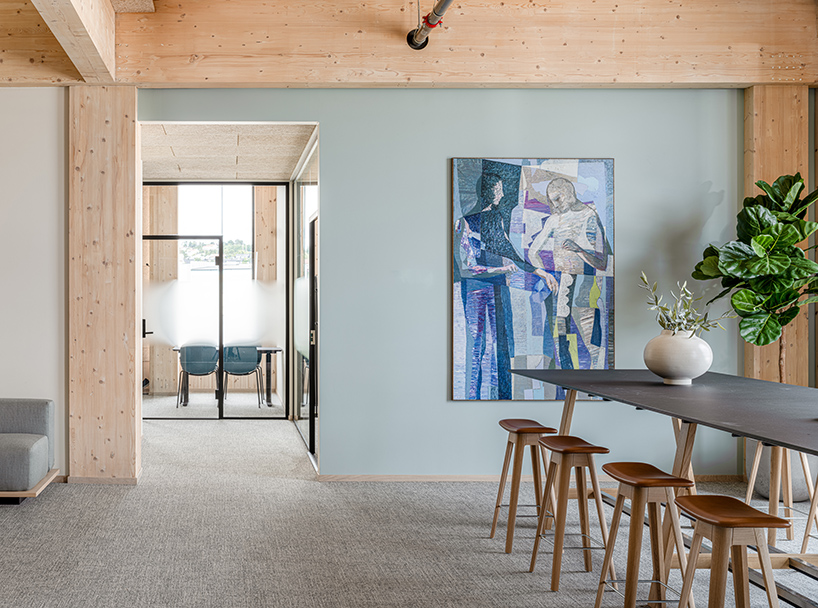 green timber curves sculpt rhythmic facade for office building in norway