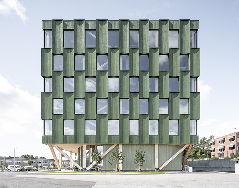 green timber curves sculpt rhythmic facade for office building in norway
