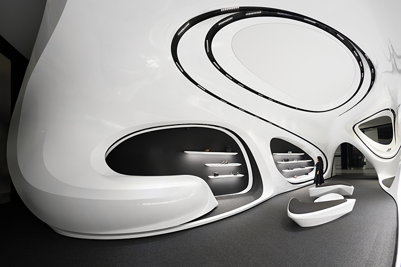 fluid black and white interiors connect curved mall corridors in tehran