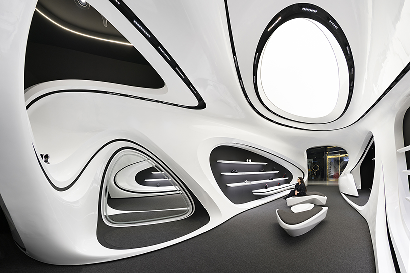 fluid black and white interiors connect curved mall corridors in tehran