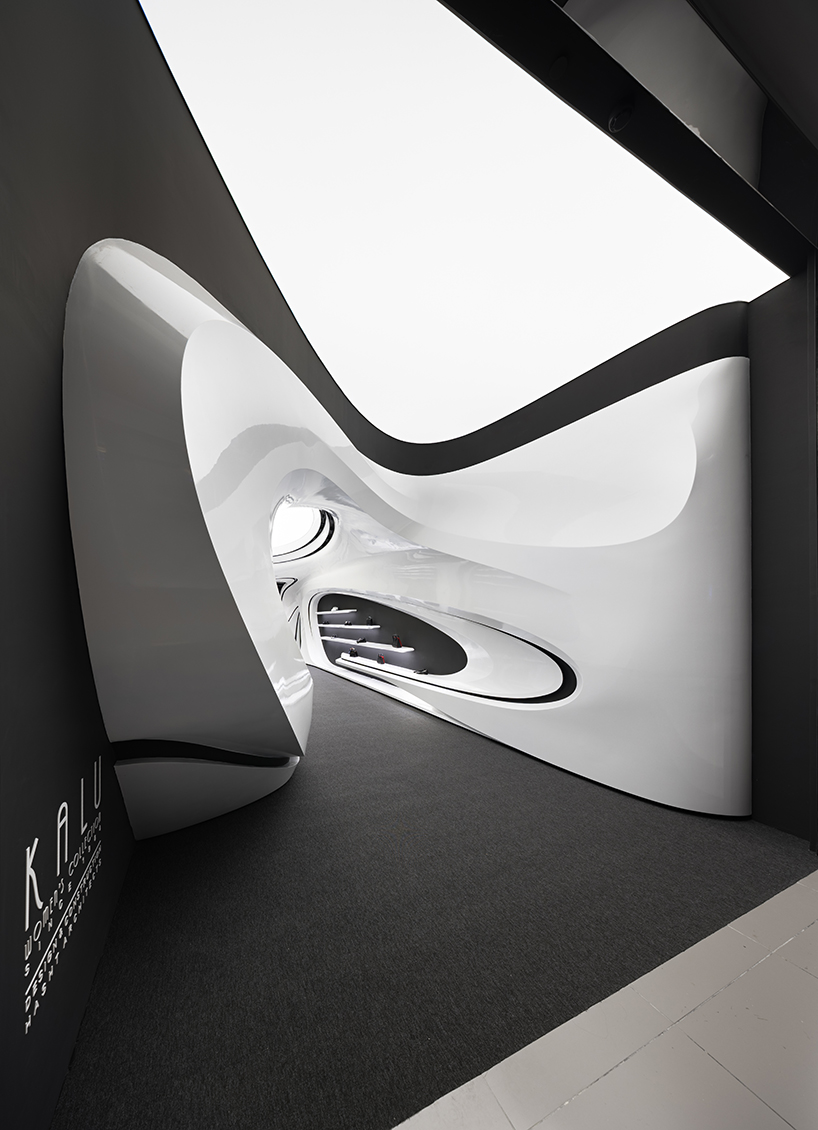 fluid black and white interiors connect curved mall corridors in tehran