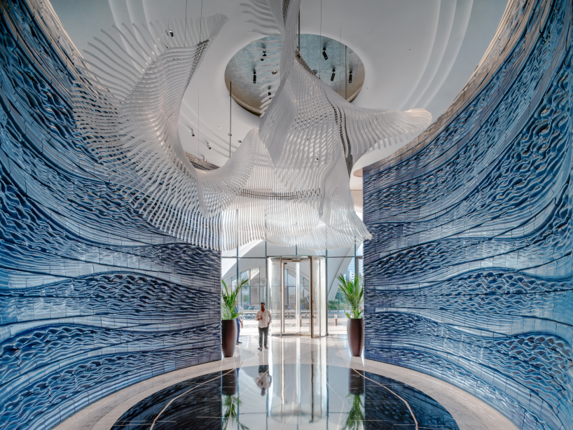 two 3D printed ceramic walls by studio RAP rise like sculpted waves at dubai hotel's entrance