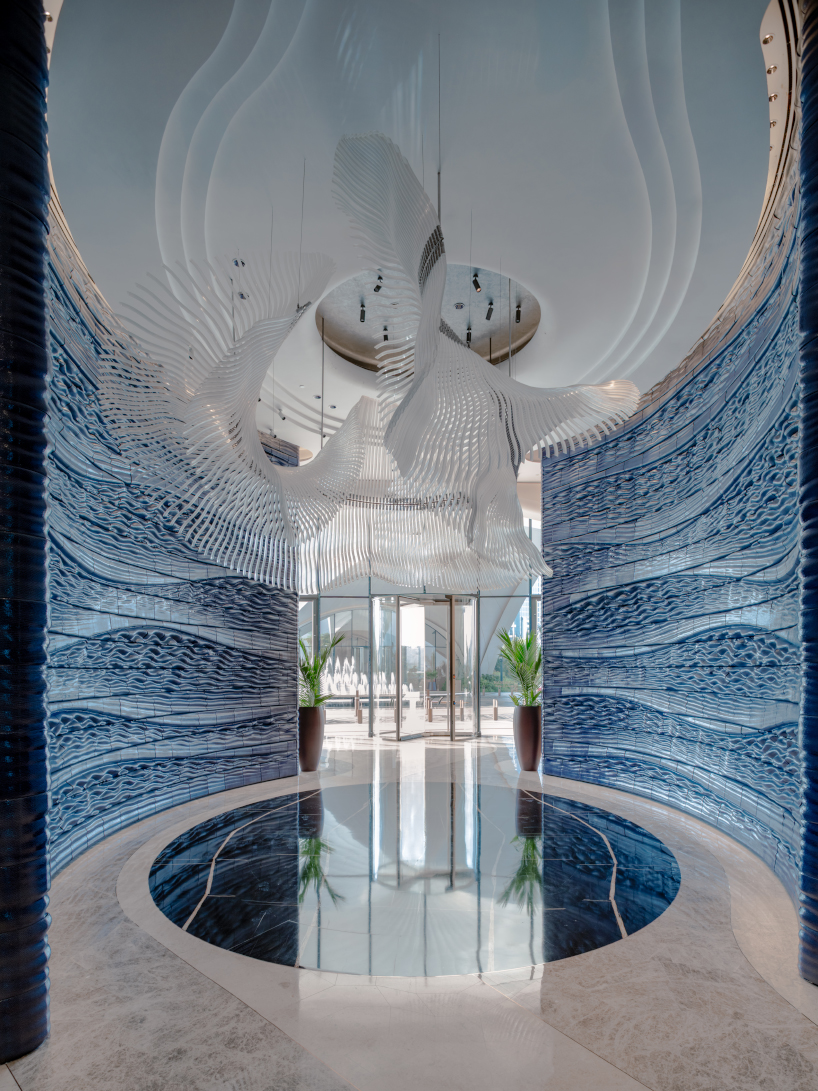 two 3D printed ceramic walls by studio RAP rise like sculpted waves at dubai hotel's entrance