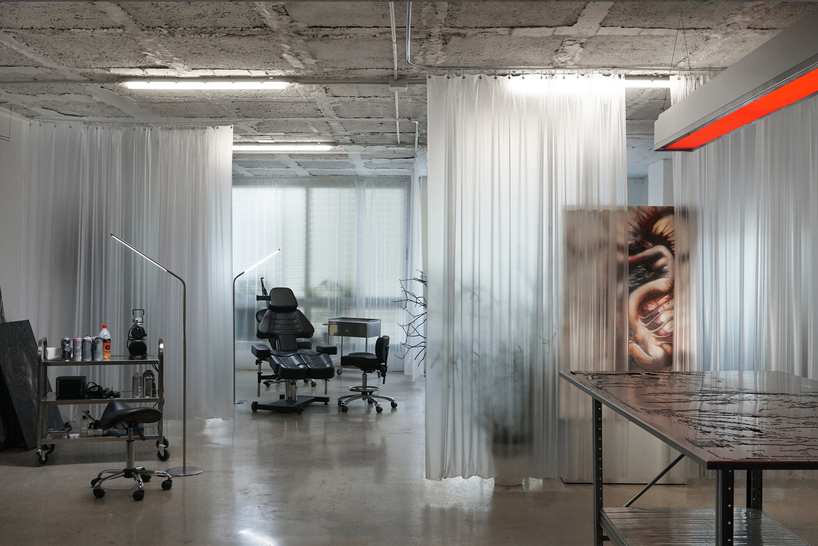 blok tattoo studio in barcelona redefines sterile spaces through concrete and steel interiors