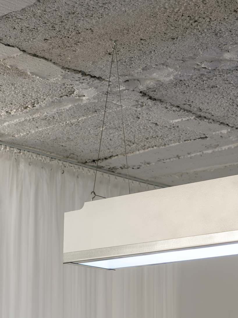 blok tattoo studio in barcelona redefines sterile spaces through concrete and steel interiors