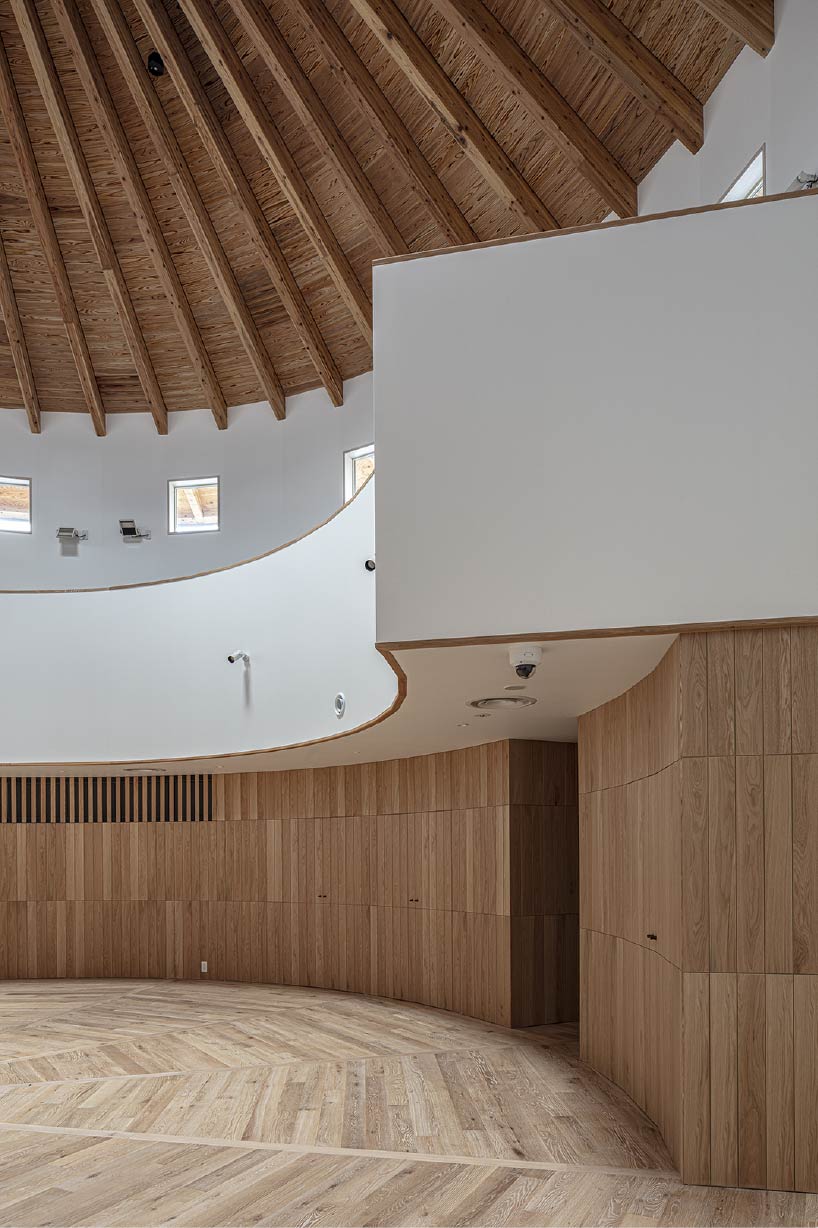 curved wooden frame shapes light-filled daycare center in japan encouraging playful learning