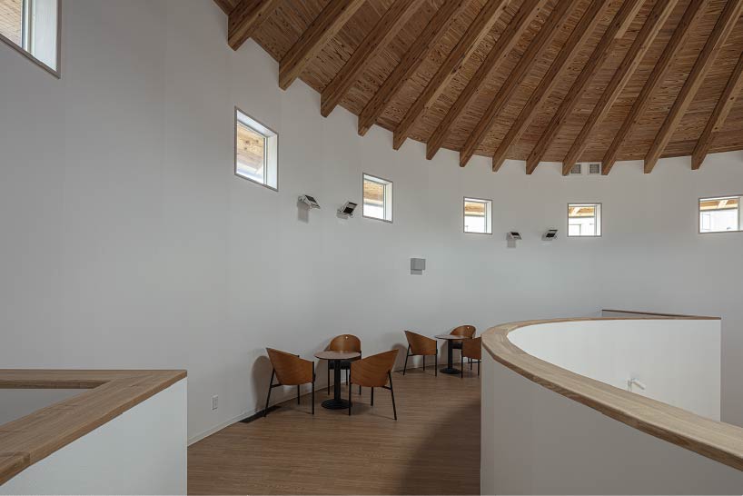 curved wooden frame shapes light-filled daycare center in japan encouraging playful learning