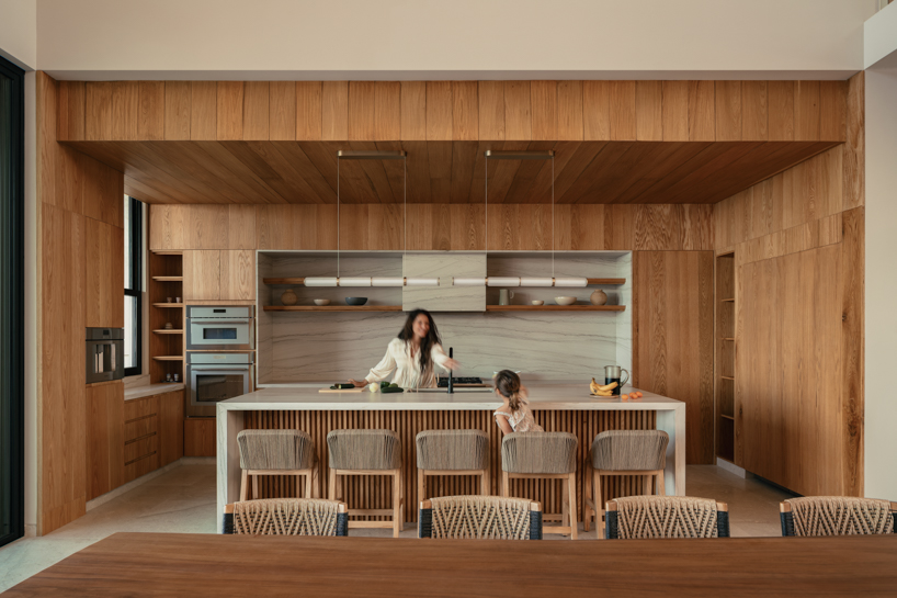 rammed-earth residence unfolds around central planted courtyard on mexico's coast