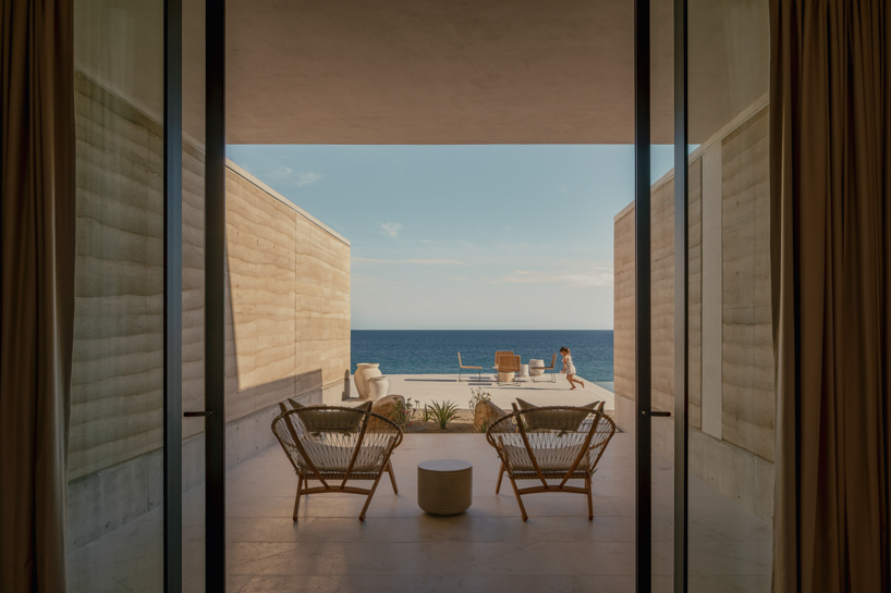 rammed-earth residence unfolds around central planted courtyard on mexico's coast