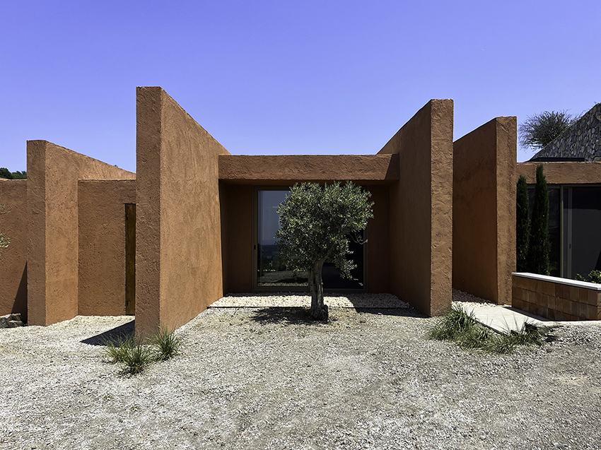red earthen-plaster office's linear volumes trace grapevine rows in rural turkey