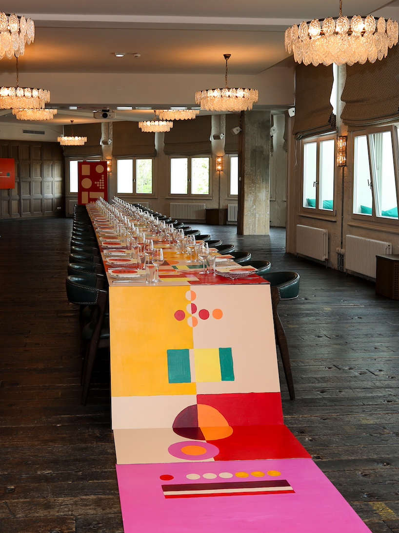35-meter hand-painted table transforms dining into an immersive installation in berlin - 8