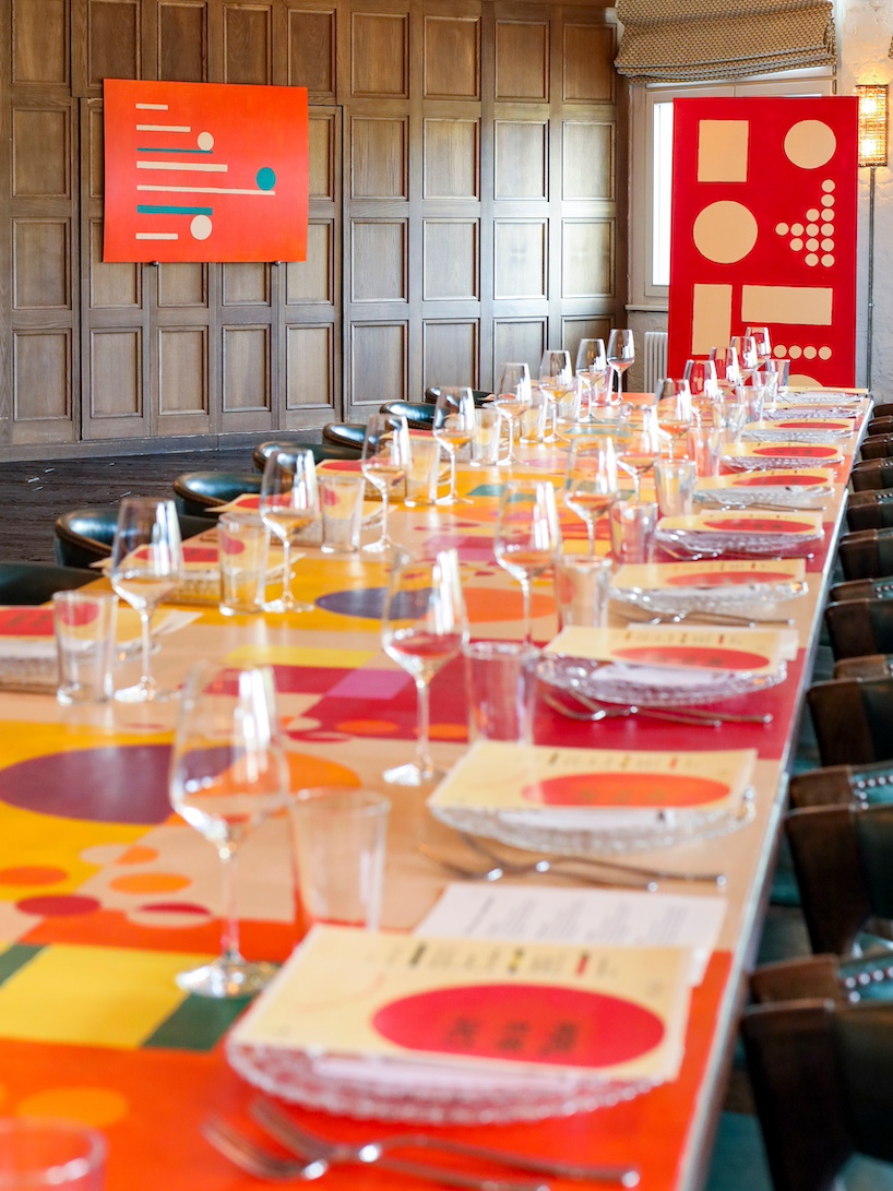 35-meter hand-painted table transforms dining into an immersive installation in berlin - 7