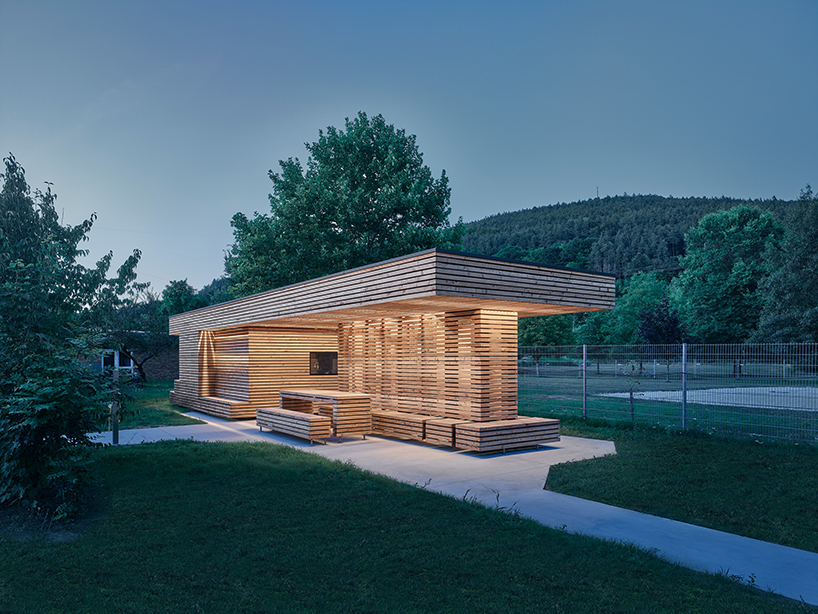 tob.studio’s timber bike station in germany resembles stacked log pile - 8
