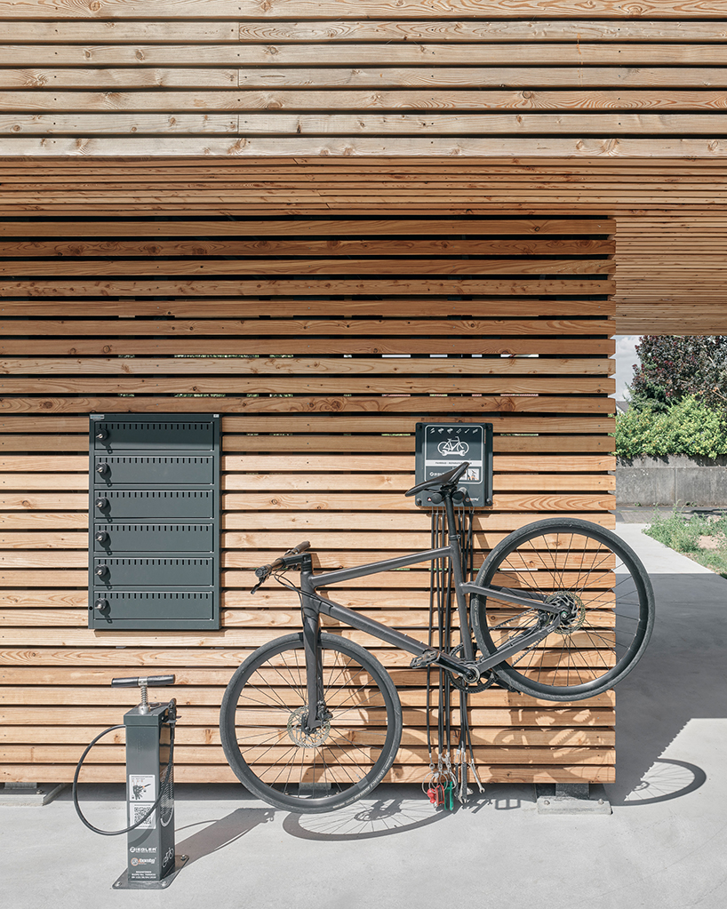 tob.studio’s timber bike station in germany resembles stacked log pile - 5