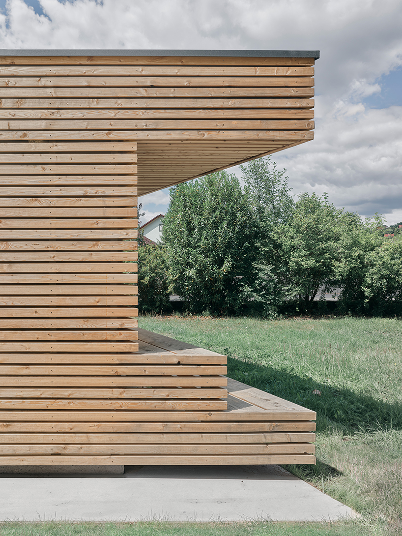 tob.studio’s timber bike station in germany resembles stacked log pile - 7