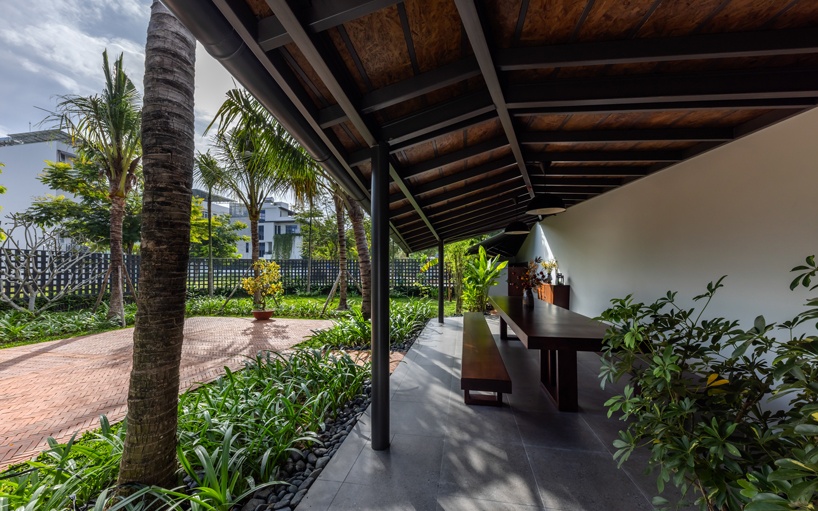 tent house expands under overlapping angular roof planes in vietnam