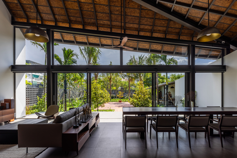 tent house expands under overlapping angular roof planes in vietnam