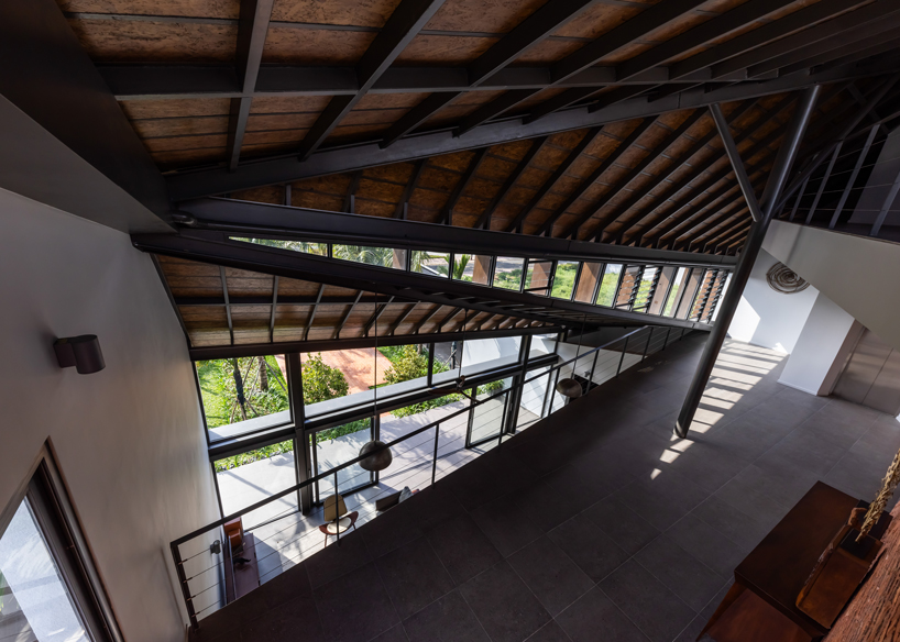 tent house expands under overlapping angular roof planes in vietnam