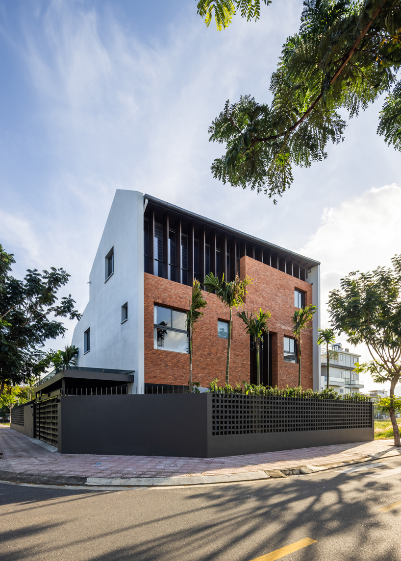 tent house expands under overlapping angular roof planes in vietnam