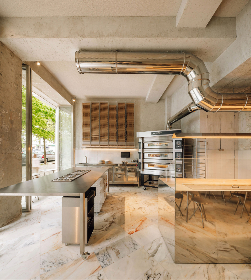 reflective steel interiors and open facade bring lisbon’s street activity into pizza restaurant