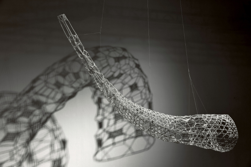 crocheted zodiac animal installations by choi+shine suspend above dark body of water