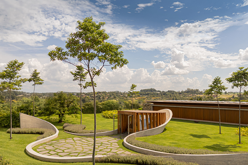 curving concrete walls encircle nest chapel’s intimate timber core in são paulo