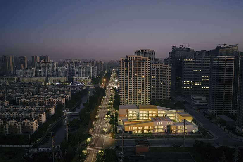 stacked color blocks and layered courtyards form a modular castle-like kindergarten in china - 11
