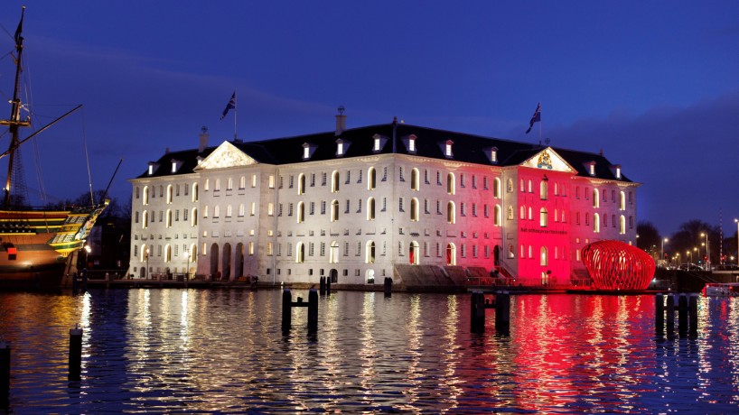 whale skeletal light installation glows red for amsterdam light festival