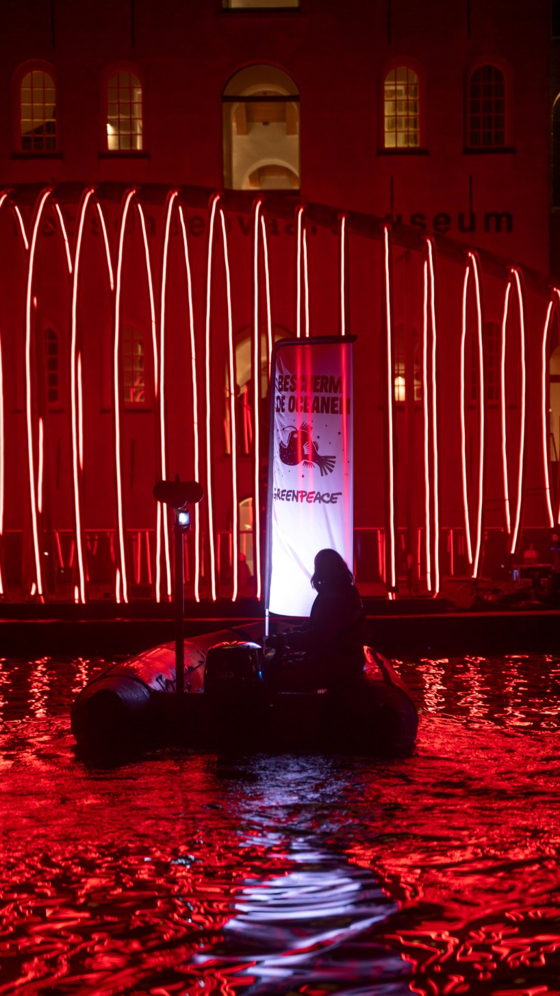 whale skeletal light installation glows red for amsterdam light festival