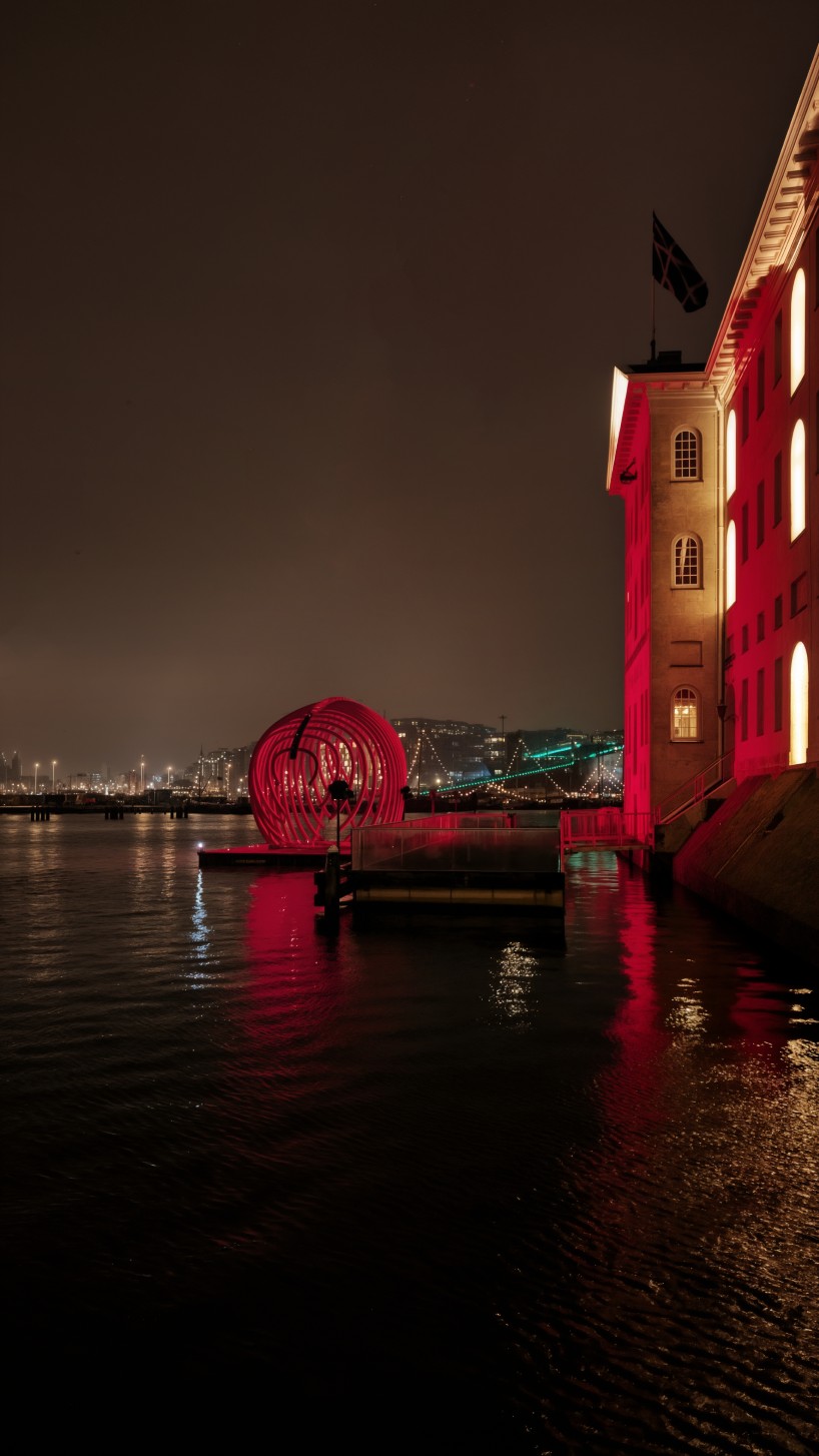 whale skeletal light installation glows red for amsterdam light festival