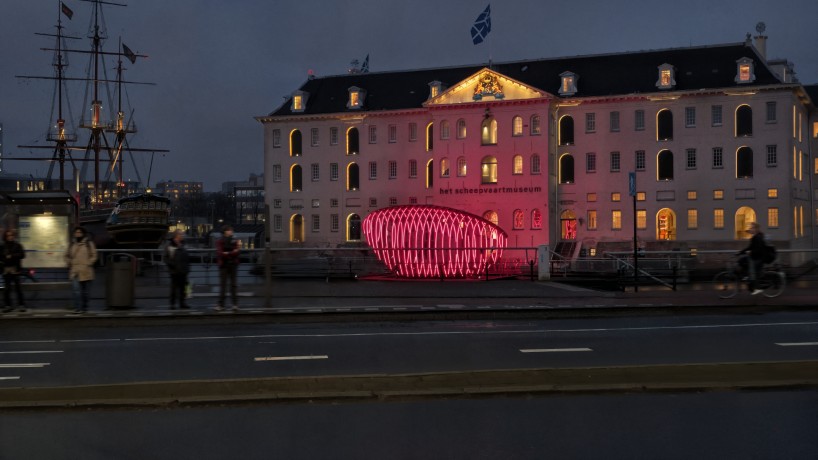 whale skeletal light installation glows red for amsterdam light festival