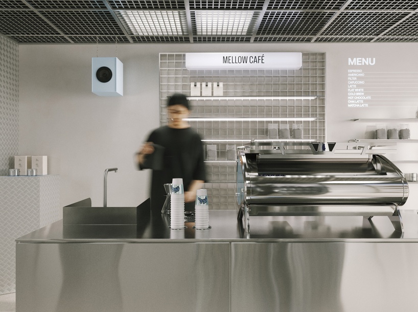 suspended metal grid ceiling meets translucent and reflective surfaces inside french café - 3