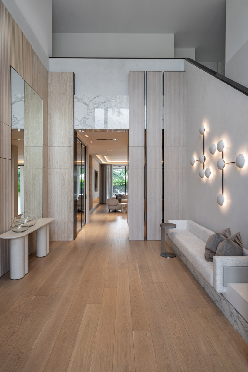 wood and porcelain interplay across curved interiors in florida renovation