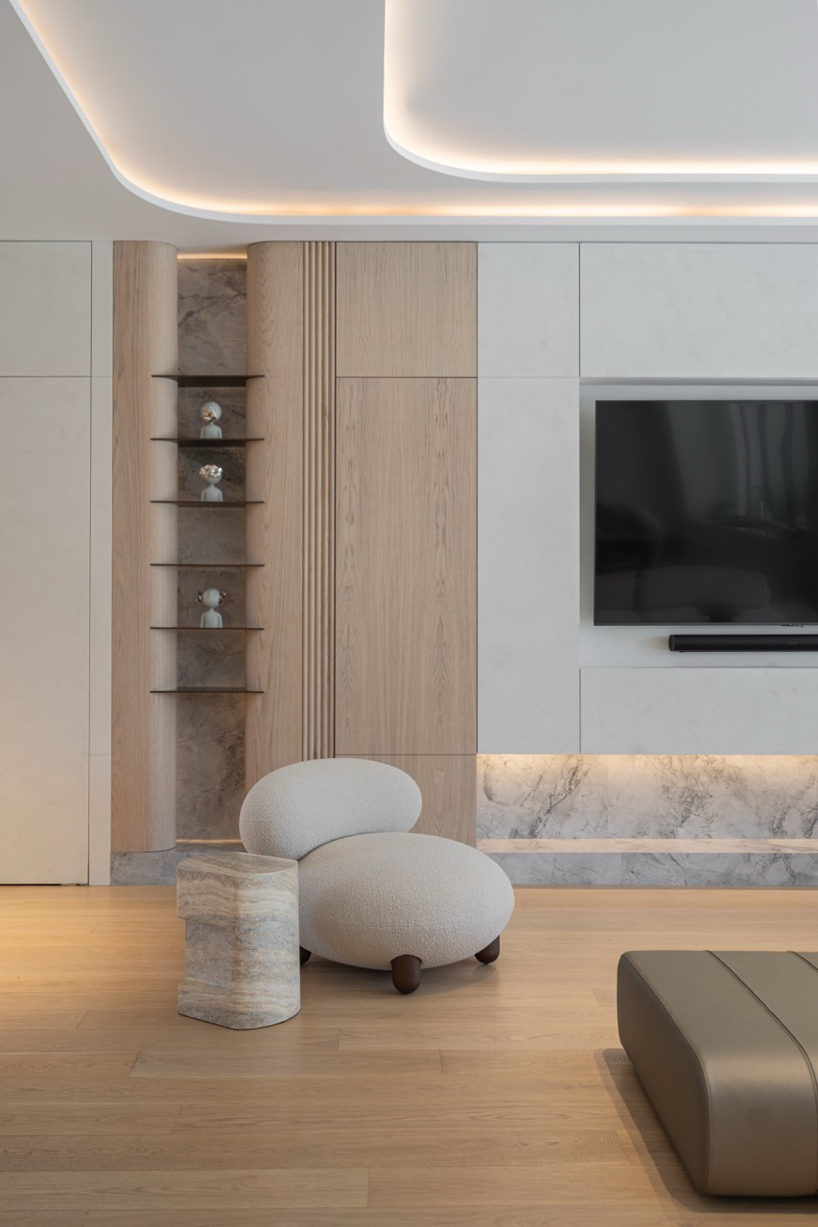 wood and porcelain interplay across curved interiors in florida renovation