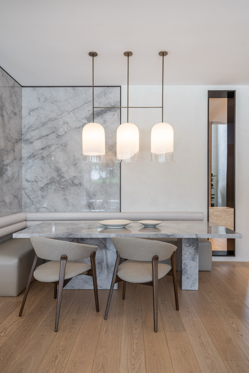 wood and porcelain interplay across curved interiors in florida renovation