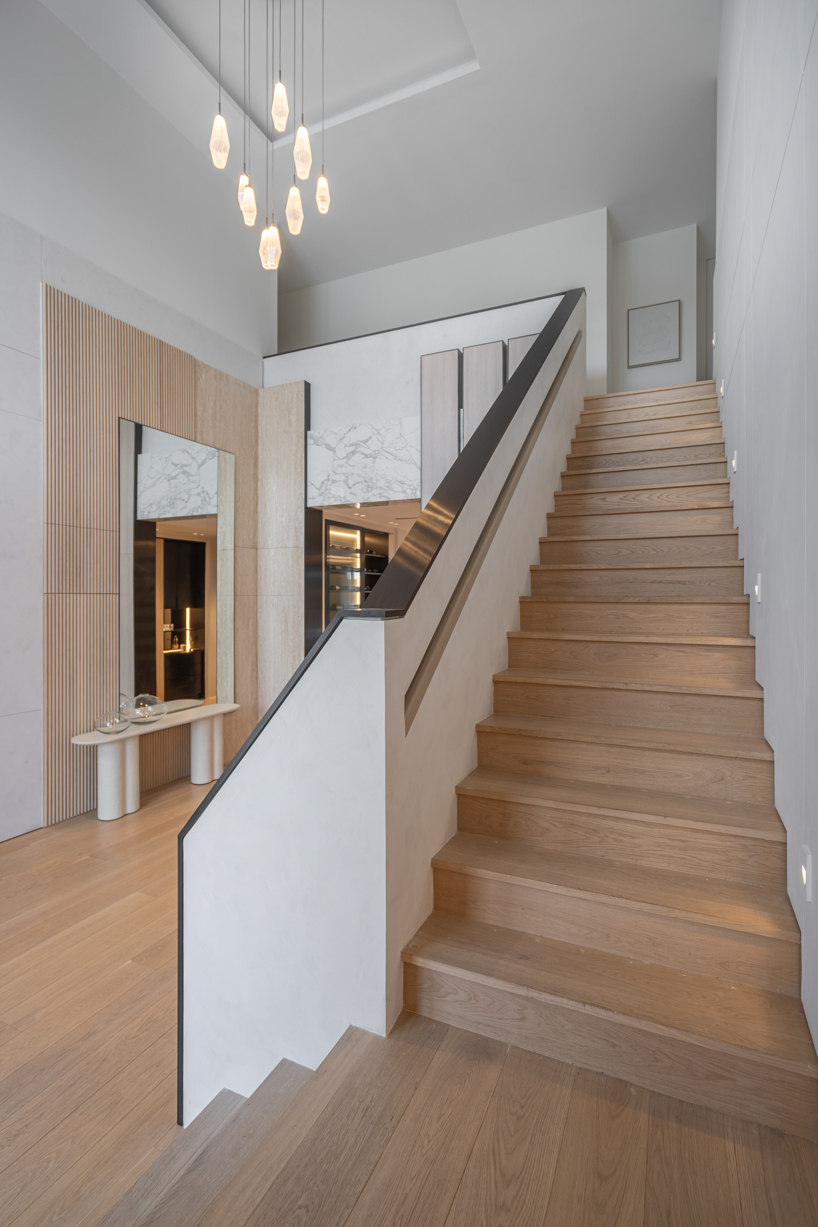 wood and porcelain interplay across curved interiors in florida renovation