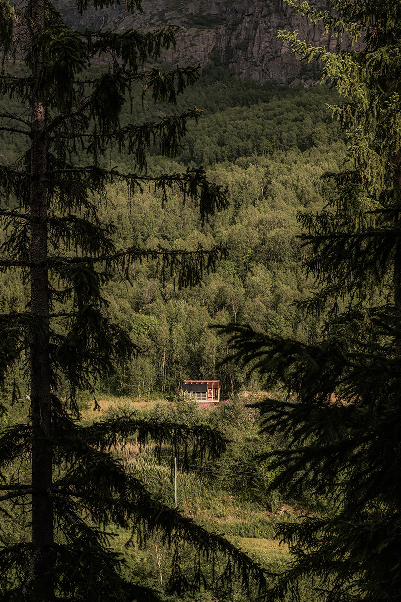 student collective builds fireplace shelter from reclaimed materials in northern norway