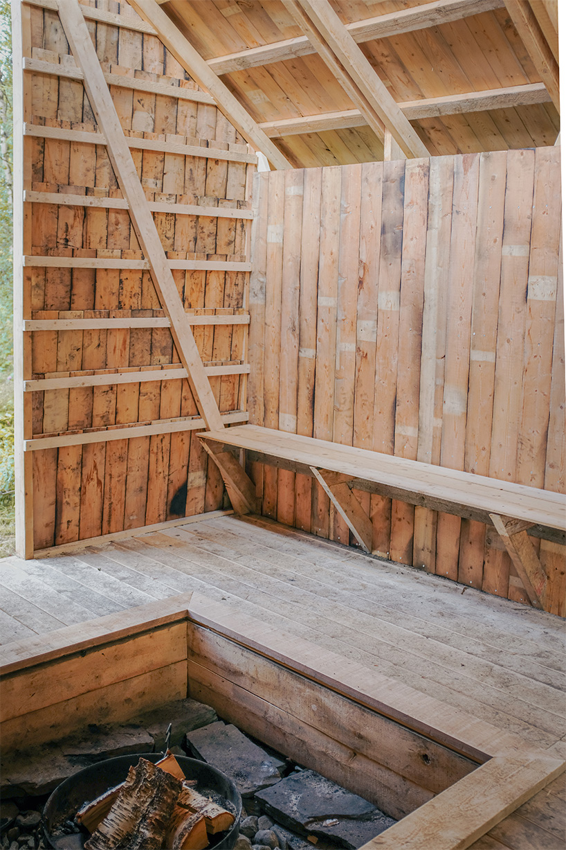 student collective builds fireplace shelter from reclaimed materials in northern norway