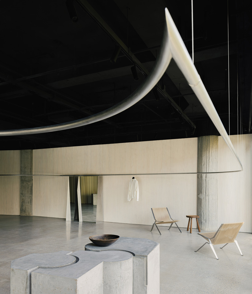 continuous steel rail traces shanghai showroom&rsquo;s sculptural interior, like a freehand drawing