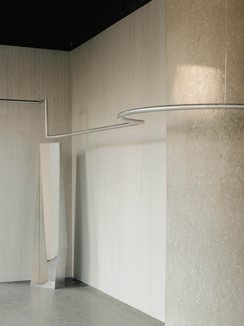 continuous steel rail traces shanghai showroom&rsquo;s sculptural interior, like a freehand drawing