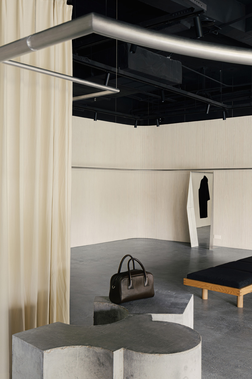 continuous steel rail traces shanghai showroom&rsquo;s sculptural interior, like a freehand drawing