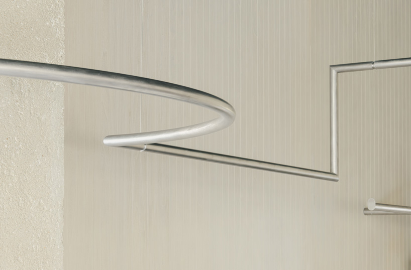 continuous steel rail traces shanghai showroom&rsquo;s sculptural interior, like a freehand drawing