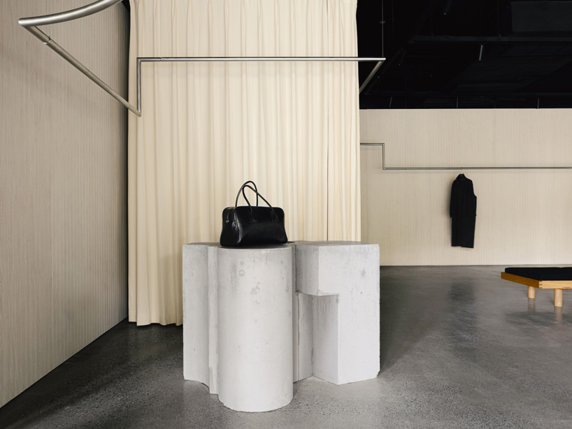 continuous steel rail traces shanghai showroom&rsquo;s sculptural interior, like a freehand drawing