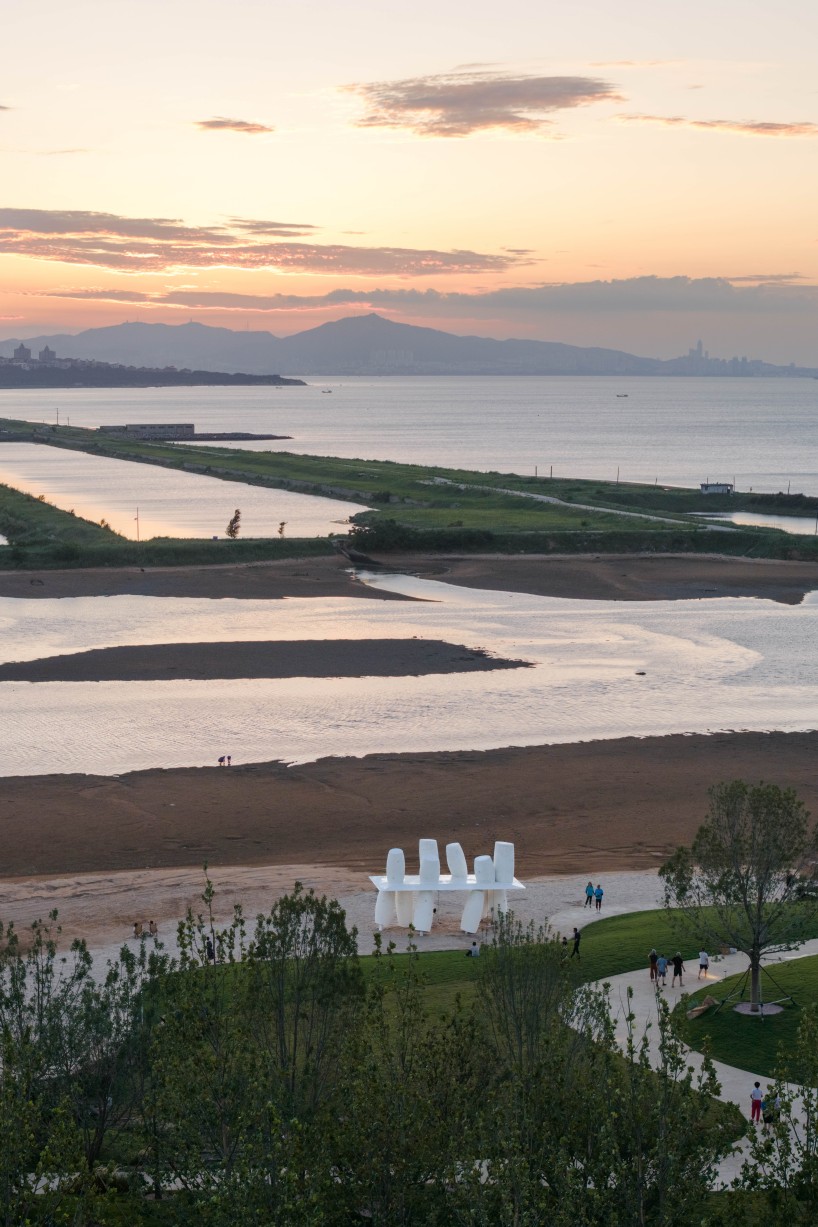 white stainless-steel cylinders form coral-like swing installation on chinese coast - 8